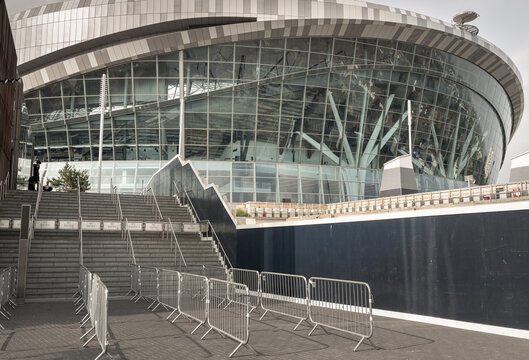 London, UK - Jun 09, 2025 - Redefining modern stadium design, the Tottenham Hotspur Stadium is an architectural masterpiece. Its facade of modular steel cladding utilizes tilted louvres to create a rh