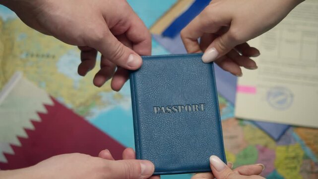 Hands pass Qatari passport to new citizen during naturalization ceremony with Qatar flag nearby.