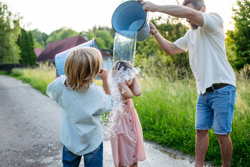 Traditional Easter Monday water ritual in rural countryside.