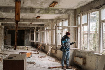 Fototapeta premium Man exploring abandoned building in Chernobyl