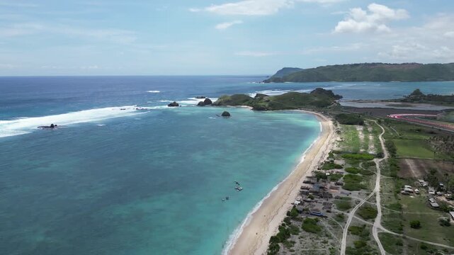 Pertamina Mandalika Circuit by the sea in Lombok, Indonesia. Stunning aerial view of the modern racetrack next to the beautiful tropical ocean and beach. Perfect for motorsport, travel, and tourism.