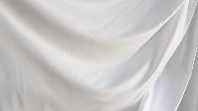 white silk fabric in motion, textile background, curtains draped in the wind