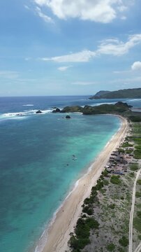 Pertamina Mandalika Circuit by the sea in Lombok, Indonesia. Stunning aerial view of the modern racetrack next to the beautiful tropical ocean and beach. Perfect for motorsport, travel, and tourism.