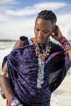 Portrait o a yound Maasai man wearing traditional clothes and bead jewellery