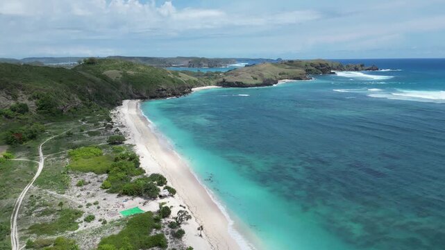 Pertamina Mandalika Circuit by the sea in Lombok, Indonesia. Stunning aerial view of the modern racetrack next to the beautiful tropical ocean and beach. Perfect for motorsport, travel, and tourism.
