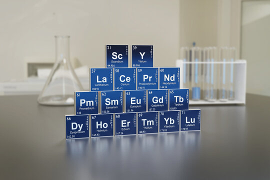 Rare earth symbols on a laboratory table. 3D illustration.
