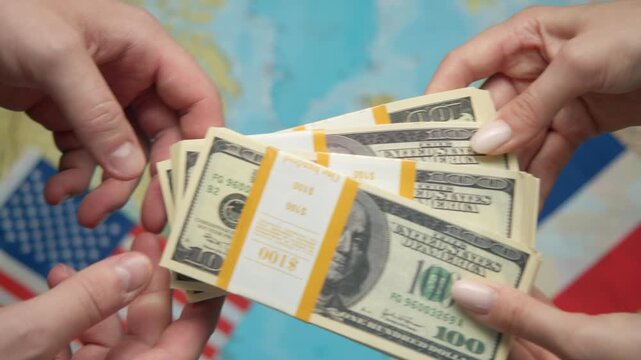 Investors exchange funds between hands against American and French flags with global map, symbolizing trade partnership.