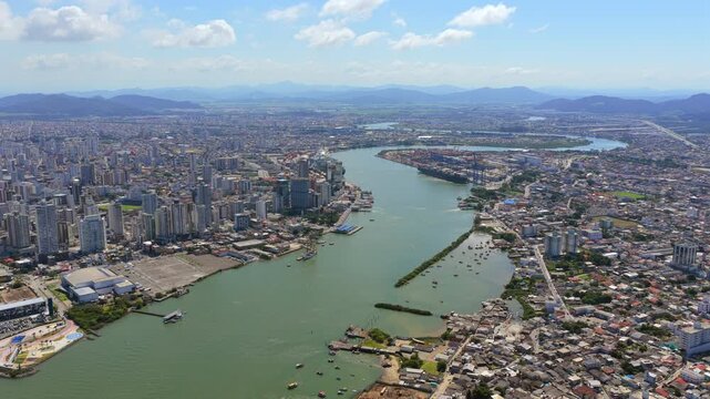 Aerial view of Port of Itajai on Itajai Acu River, showcasing cargo logistics, shipping and urban infrastructure.