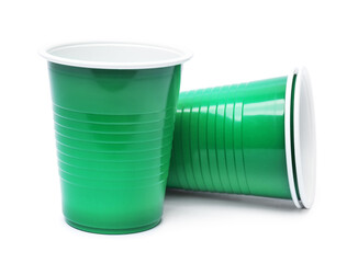 Obraz premium Disposable green plastic cups isolated on white