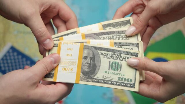 American financier passes stack of dollars to Brazilian diplomat against world map with US and Brazilian flags for agricultural partnership.