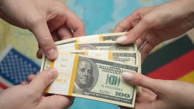 American industrialist passes stack of dollars to German representative against world map with US and German flags for automotive collaboration.