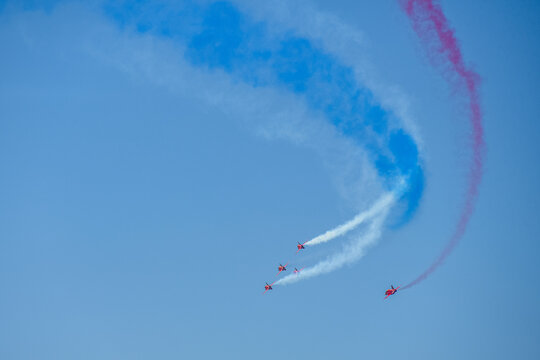 A group of aerobatic jet aircraft flying in perfect formation du