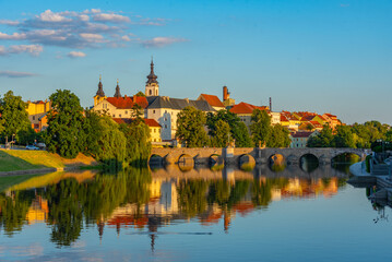 Fototapeta premium Sunset panorama of Pisek with the stone bridge, Czech republic