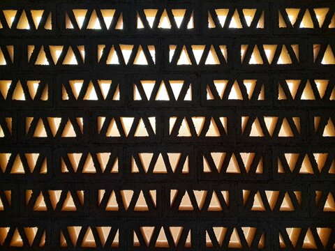 A wall featuring geometric triangle-shaped breeze blocks (or ventilation blocks), typically used in tropical or arid climates to allow airflow while providing shade.