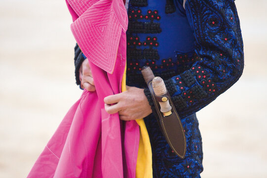 A traditional Spanish Traje de Luces is a hand-embroidered silk suit with gold sequins, worn by bullfighters for elegance and bravery.