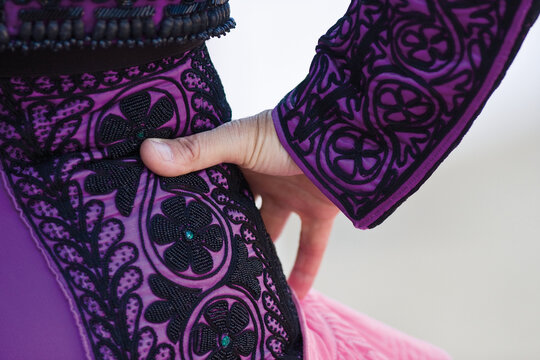 A traditional Spanish Traje de Luces is a hand-embroidered silk suit with gold sequins, worn by bullfighters for elegance and bravery.