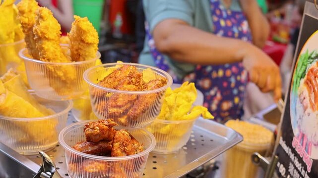 Street Food Fried Chicken and Snacks Display in Plastic Cups Bangkok Night Market