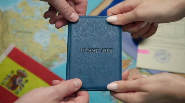 New citizen receives Spanish passport from hands amid citizenship documents and EU Spain flag.