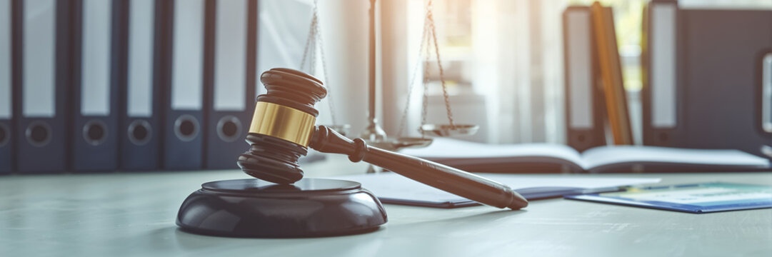 the gavel of justice lies on the table, folders with documents