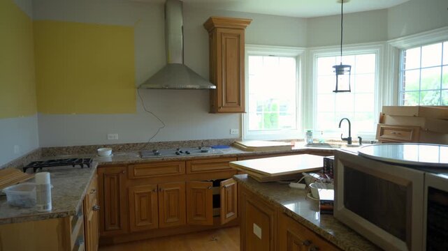 View of outdated kitchen interior during demolition process before installation of new cabinets and appliances.