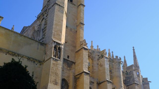 Narbonne Old Gothic stone cathedral tower blue sky architectural details