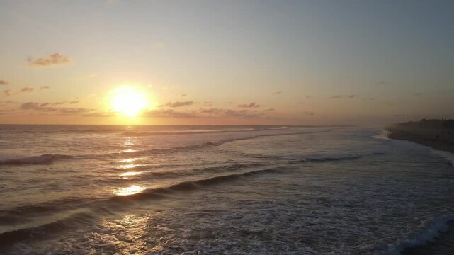 Golden Sunset on Beach with Waves and Sun Reflection
