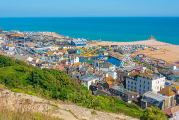 People are enjoying a sunny day on a beach in Hastings, England © dudlajzov