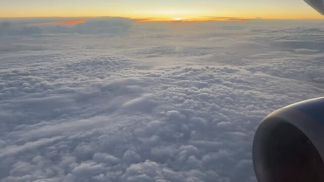 Endless cloudscape seen from airplane window at sunset. Soft colors and calm atmosphere. Suitable for serenity concepts meditation visuals aviation and inspirational content.
