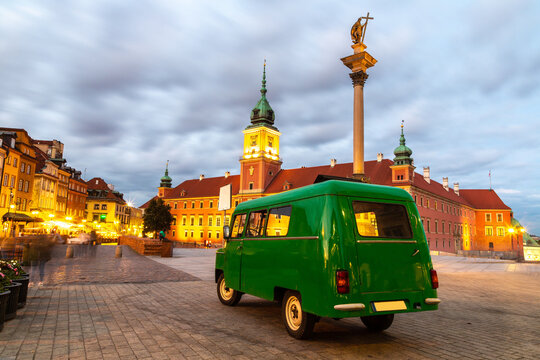 Retro car near Royal Castle and Sigismund column in Warsaw