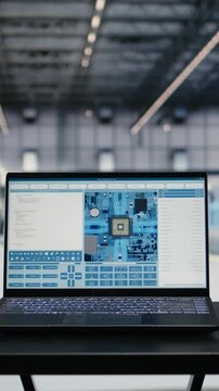 Vertical video Monitoring PCB components hardware fabrication, laptop software and engineer in microchip foundry. Designing semiconductor parts, notebook program and SoC architect in manufacturing