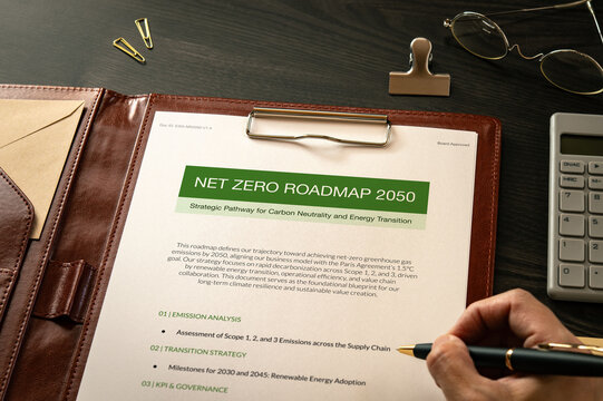 Environmental concept of Net Zero Roadmap 2050 on mock with calculator, pen, clips. Sustainable development and ecology focused imagery.
