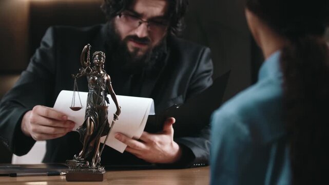 Lawyer reviewing legal documents with client in office setting. Professional legal consultation concept.
