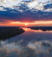 Obraz premium Vistula River near Warsaw at sunset with mirrored sky reflections