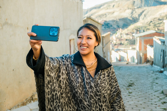 A dark-skinned Latina woman taking a selfie while traveling  in huanuni,  oruro - travel concept