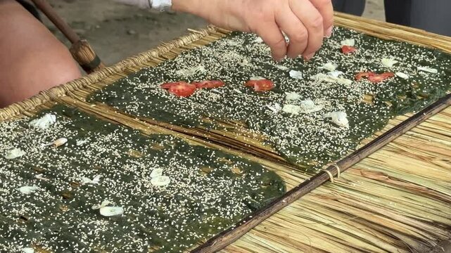 Making Lao River Weed Snacks (Kaipen): Seasoning with Garlic, Tomato and Sesame Seeds