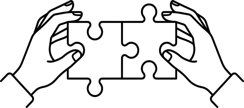 Two hands holding matching jigsaw puzzle pieces together for partnership and teamwork concept representing successful collaboration in professional environment