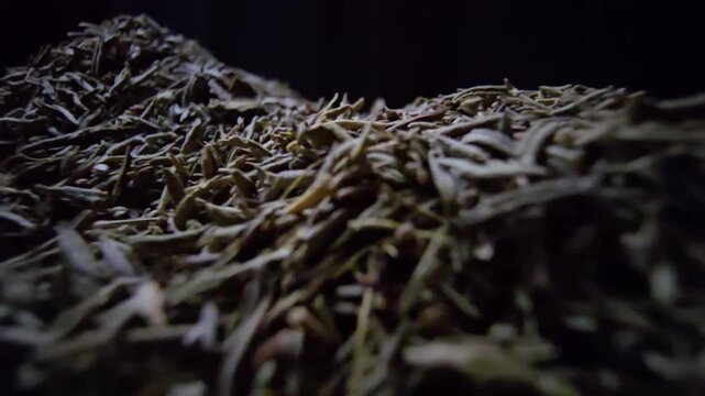 Extreme macro close-up of dried thyme leaves on a wooden surface with a black background. Slow cinematic probe lens movement revealing intricate textures and herbal details.