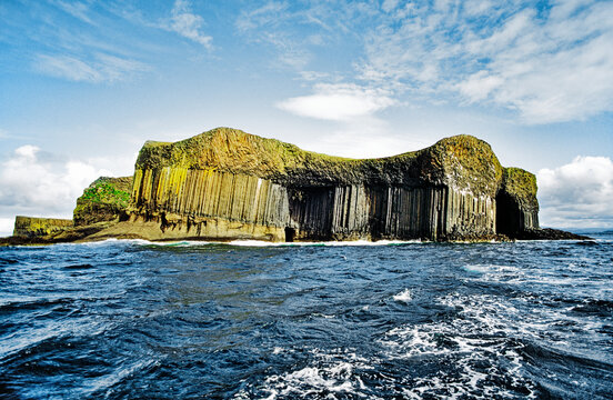 Basalt rock columns of the island of Staffa, Inner Hebrides, Scotland. Entrance to Fingal's Cave on right side
