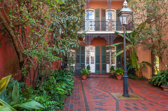 Cozy front yard of the typical French Quarter house adorned with green plants, New Orleans, USA
