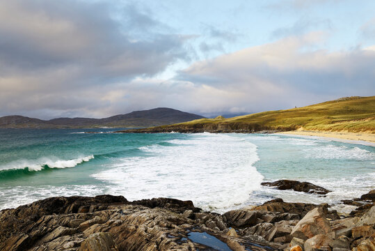 Traigh Iar beach on Harris, Outer Hebrides, Scotland. MacLeods Stone Clach Mhic Leoid prehistoric standing stone visible on skyline above beach end