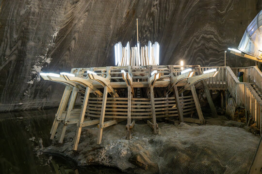 Turda, Romania - 19 Jan 24: Wooden circular platform by the underground lake in Salina Turda