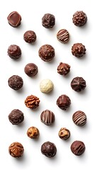 Obraz premium Assorted chocolate truffles with various toppings and coatings on white background