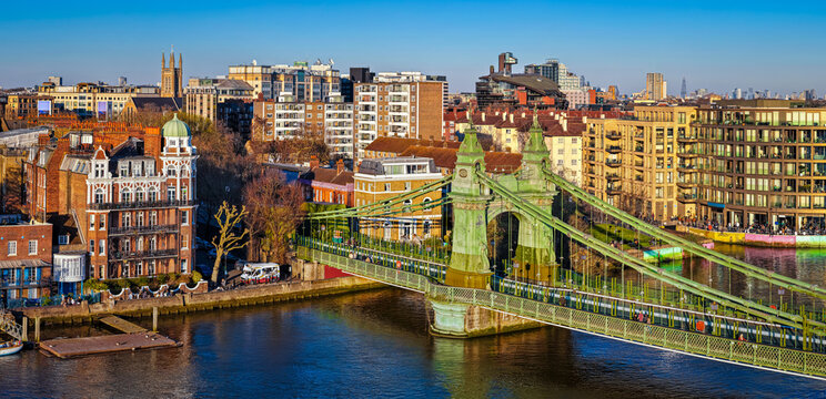 Hammersmith Bridge Over River Thames with London Skyline in Golden Light