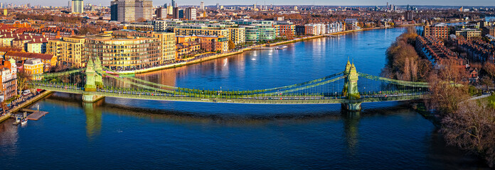 Hammersmith Bridge Over River Thames with London Skyline in Golden Light