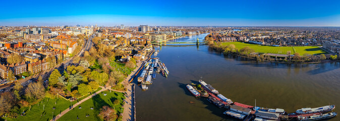 Hammersmith Bridge Over River Thames with London Skyline in Golden Light