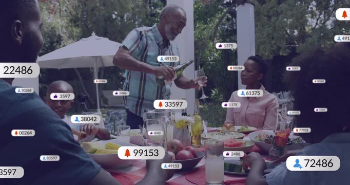 Senior man pouring drink while serving family, sparking tech badges multiplying over table items