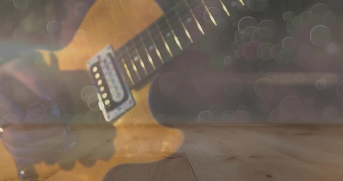 Amber guitar and hands entering frame starting picking, fingering and sliding, creating soft mood