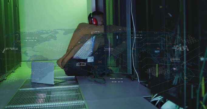 Male tech crouching datacenter laptop alert causing adjusting cables while green HUD marking ports