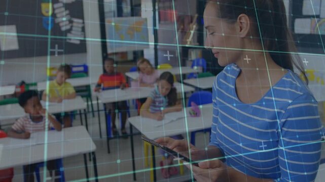 Teacher tapping tablet while monitoring student work in classroom, grid overlay tracking notebooks