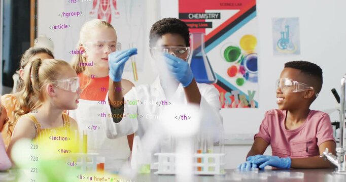 Lead student raising and turning test tubes, classmates leaning, comparing colored liquids for demo